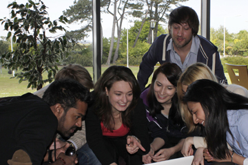 Students on the International Business MLitt programme gathered around a table